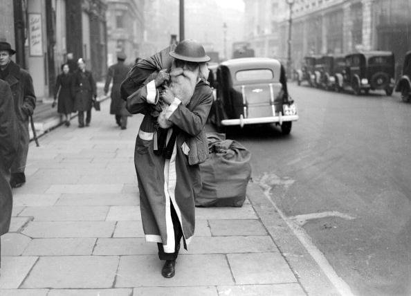 War and Conflict, World War II, People, pic: December 1940, A British soldier dessed in a Father Christmas suit on a London street